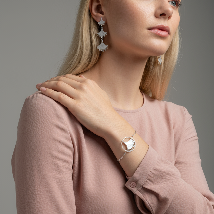 Woman wearing a Mother Of Pearl and Zircon Bracelet from Cirque D'Or in Rhodium on Sterling Silver finish.