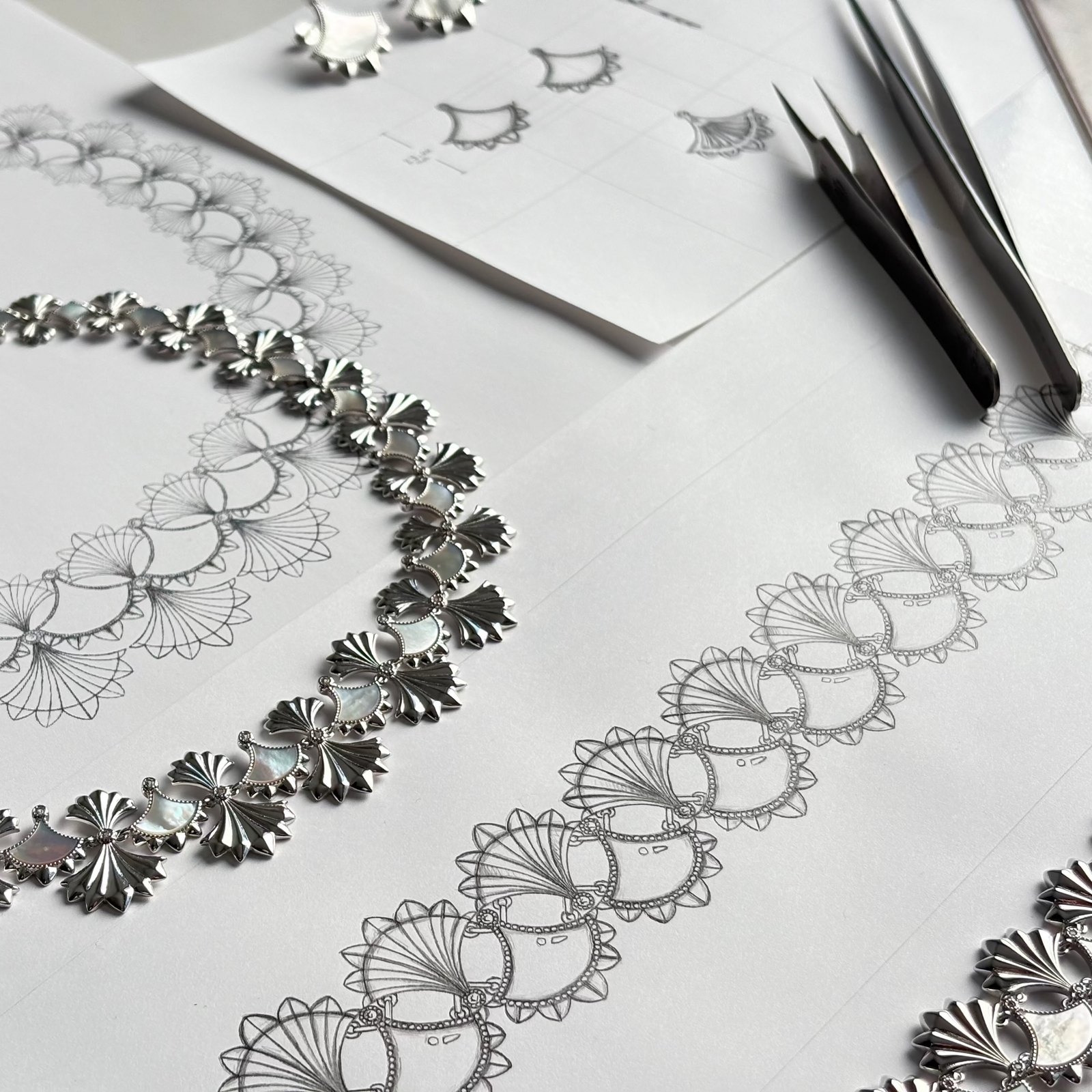 Cirque D’Or Mother of Pearl earrings shown beside original jewellery drawings
