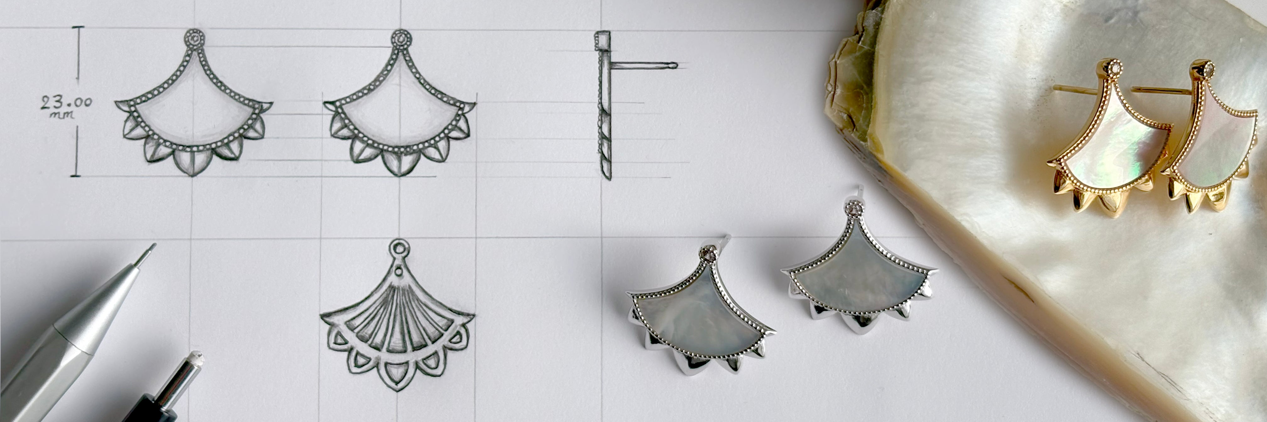 Detailed hand‑drawn jewelry sketches alongside finished gold and silver mother‑of‑pearl earrings, illustrating Cirque D’Or’s design process.