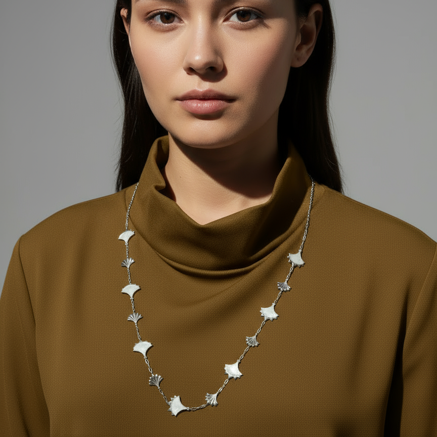 Woman wearing a Mother Of Pearl and Zircon necklace from Cirque D'Or in Rhodium on Sterling Silver finish.