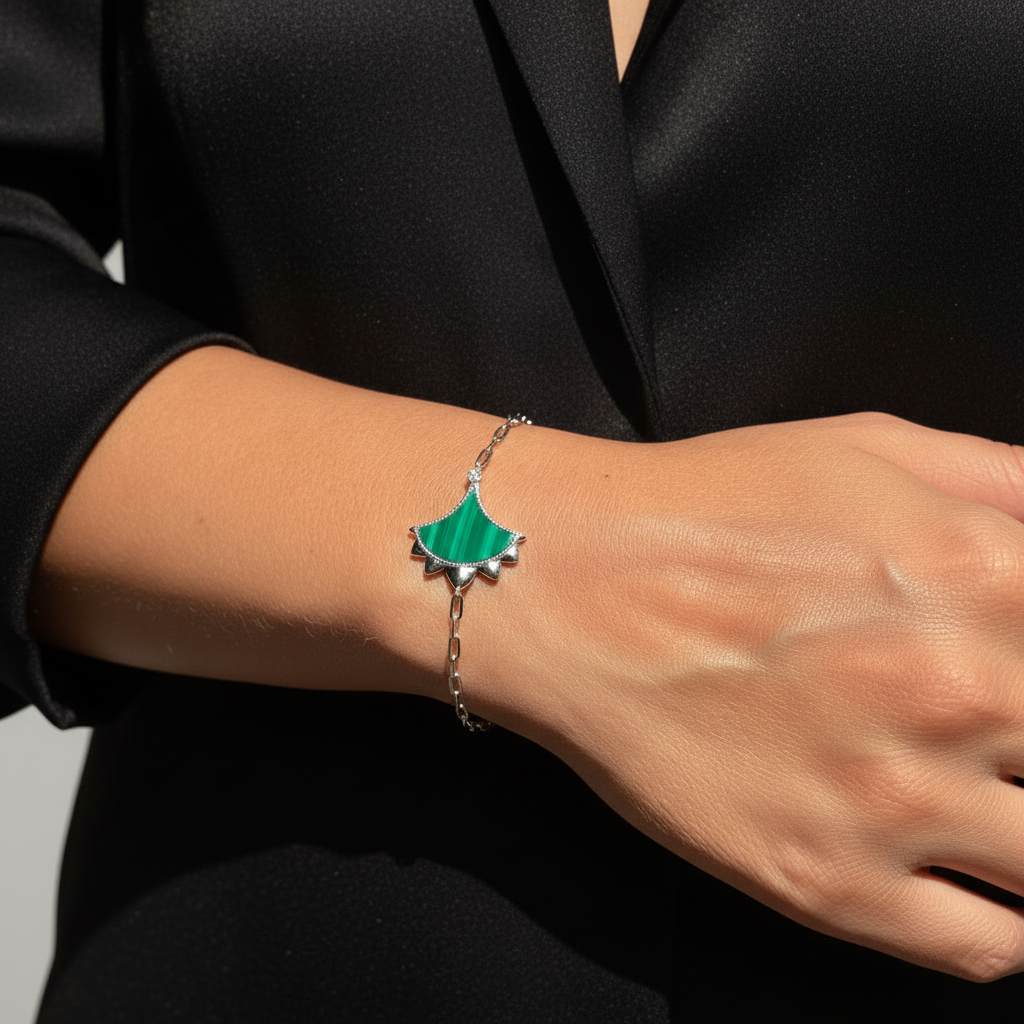 Woman wearing a Malachite and Zircon Bracelet from Cirque D'Or in Rhodium on Sterling Silver finish.