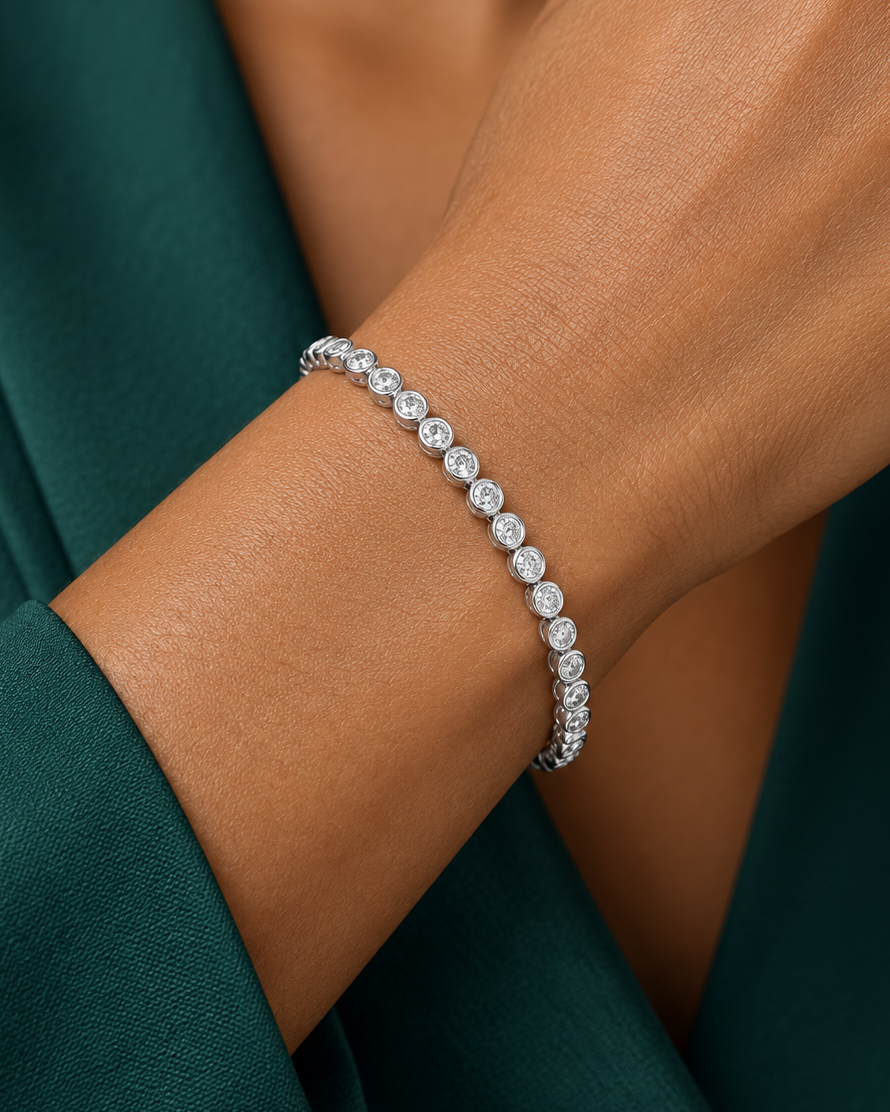 Zircon bracelet worn on a wrist against a green blouse